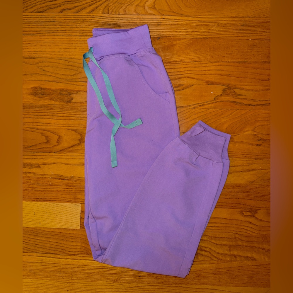 Purple jogger scrubs with light blue drawstrings